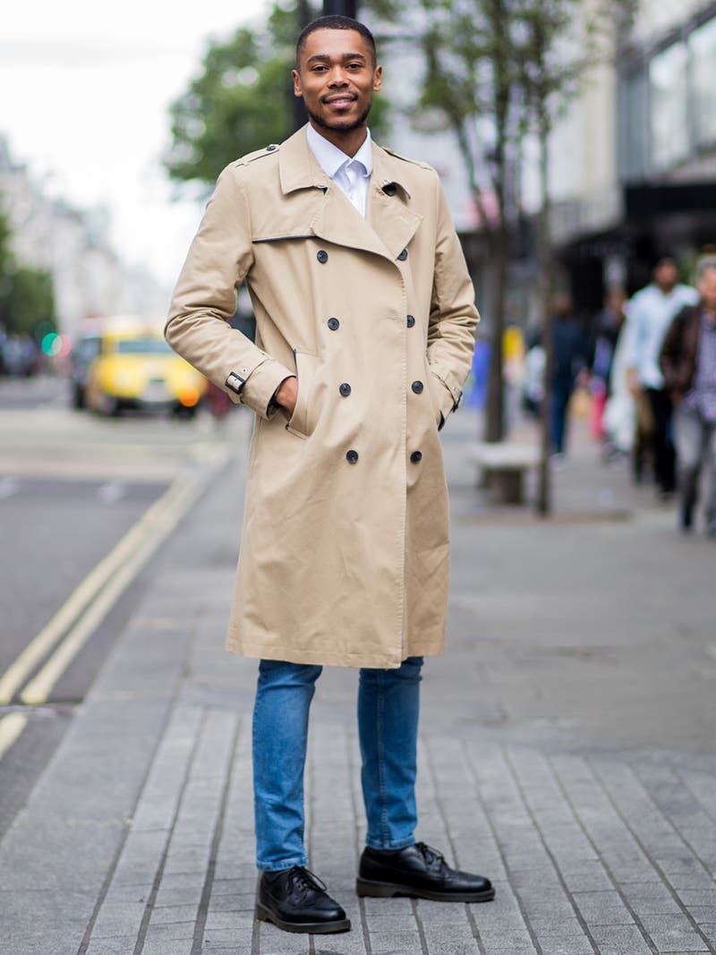 Men's outfit idea for 2022 with neutral trench coat, white dress shirt, mid blue jeans, oxford / derby shoes. Suitable for spring and fall.