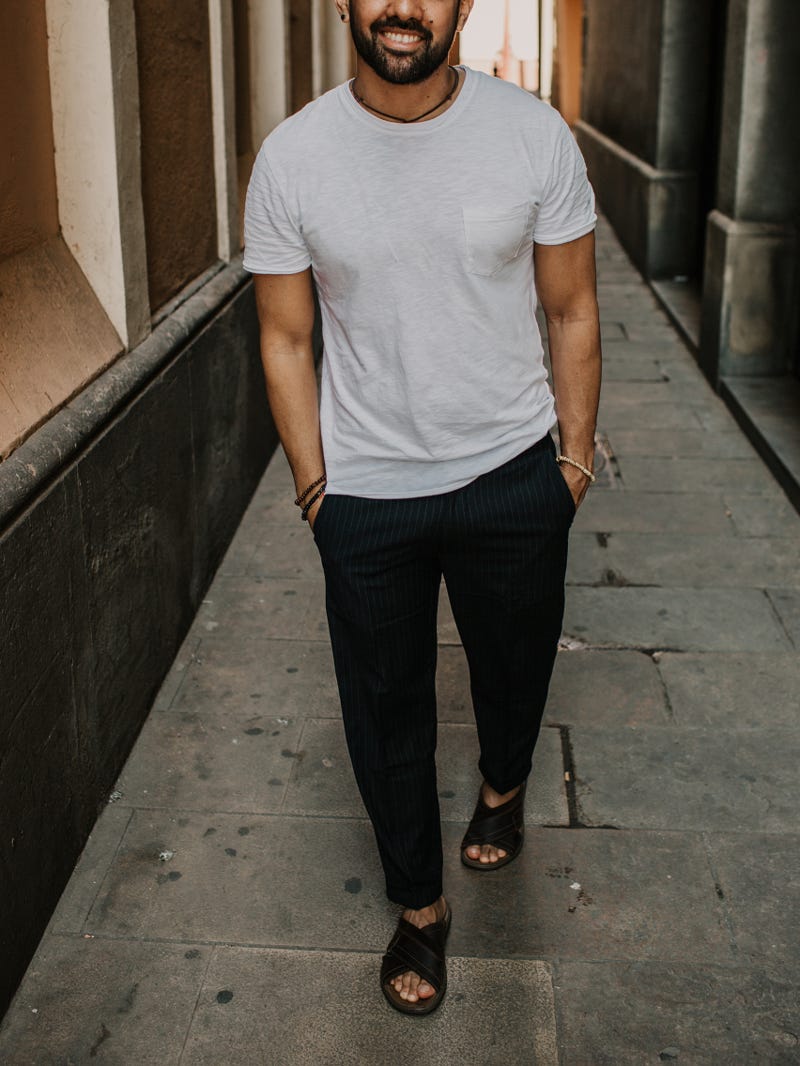Men's outfit idea for 2022 with gray crew neck t-shirt	, navy linen pants, sandals. Suitable for summer.